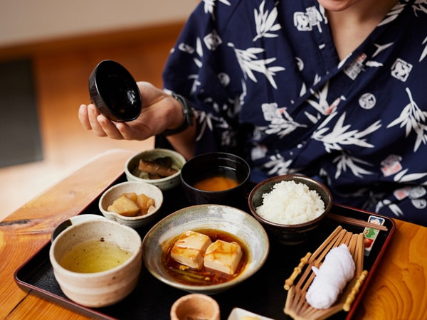a person eating Japanese meal at Shizuka Ryokan Japanese Country Spa