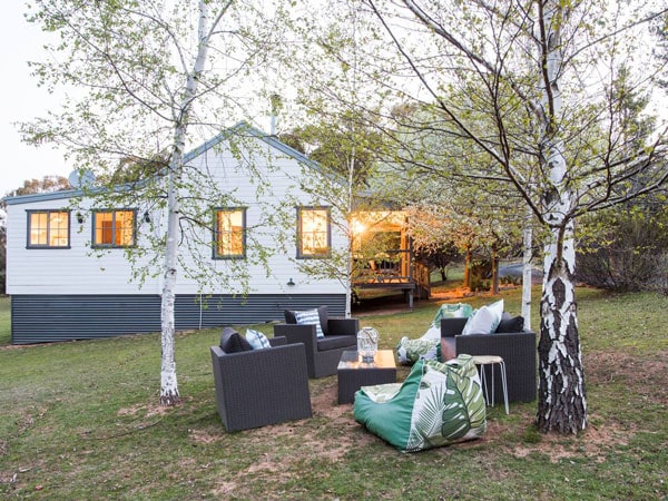 a spacious orchard with a seating area outside The Guesthouse, Hill End