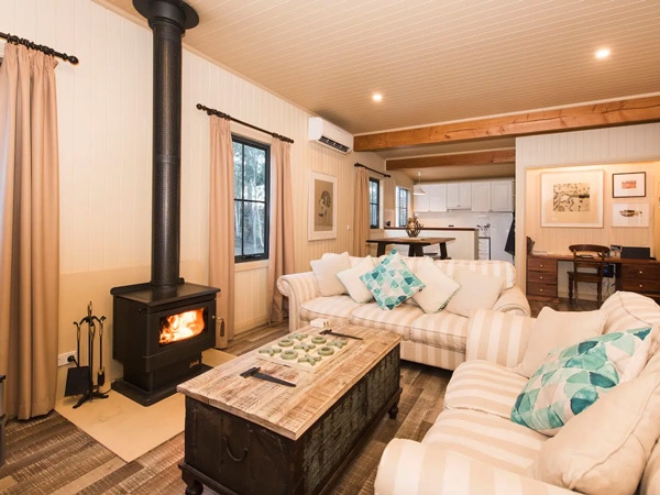 a vibrant living room interior with a fireplace at The Guesthouse, Hill End