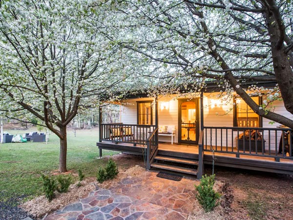 flowers blooming outside the beautiful exterior of a cottage at The Guesthouse, Hill End