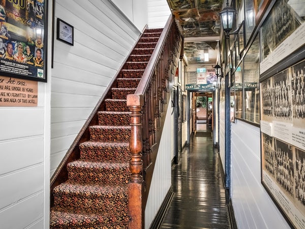 a rustic staircase inside The Historic Jamberoo Pub