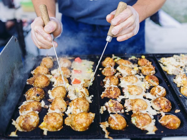 making takoyaki in one of the food stalls at The Little Burley Market, Canberra
