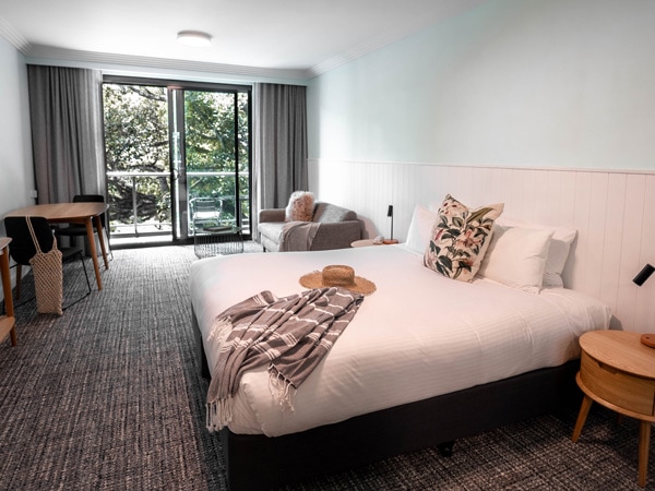 a bedroom with a balcony in The Sebel Harbourside Kiama