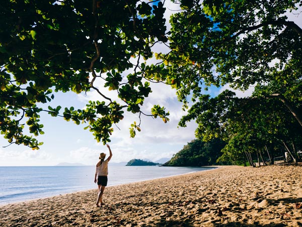 a girl walking on Trinity Beach, Cairns