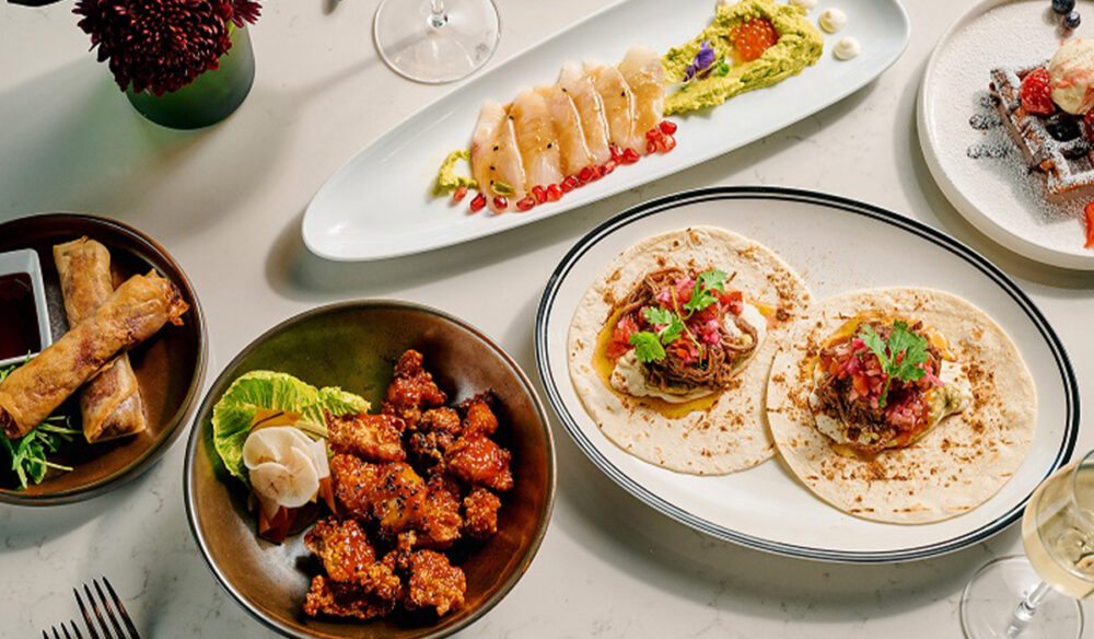A table topped with plates of food and drinks.