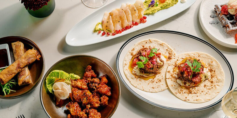 A table topped with plates of food and drinks.