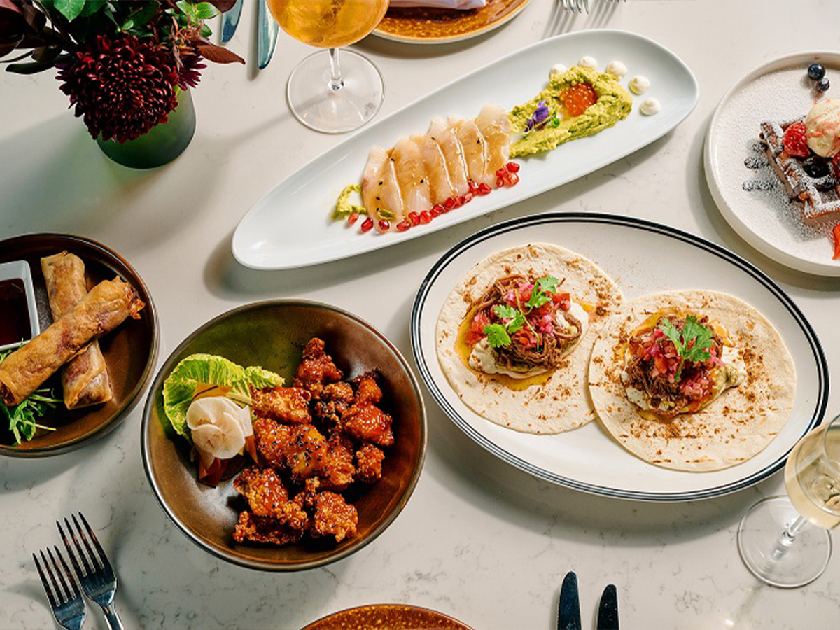 A table topped with plates of food and drinks.