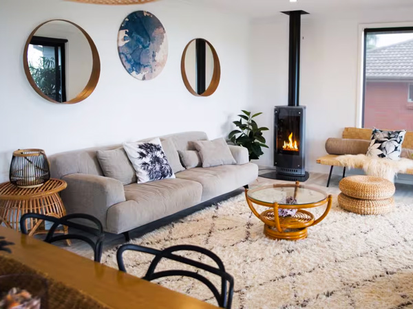 a living room with a fireplace at The Werri Shack, Kiama