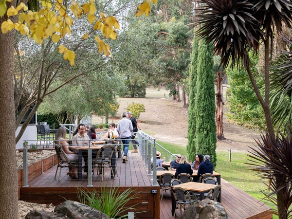 people enjoying lunch on the outdoor deck of Attwoods Wines