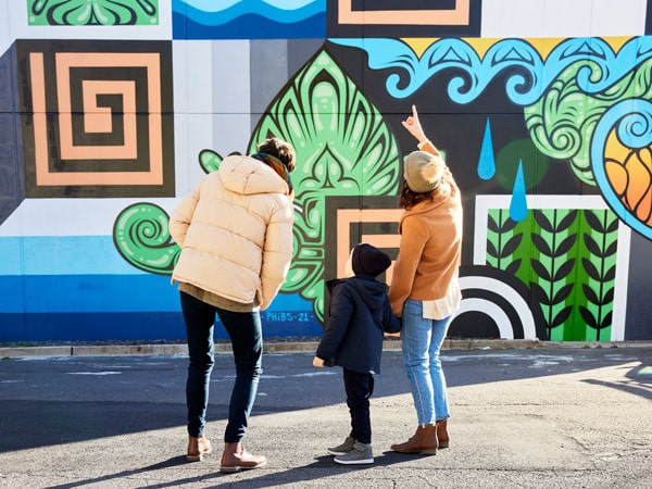 a family admiring the Braddon street art, Canberra