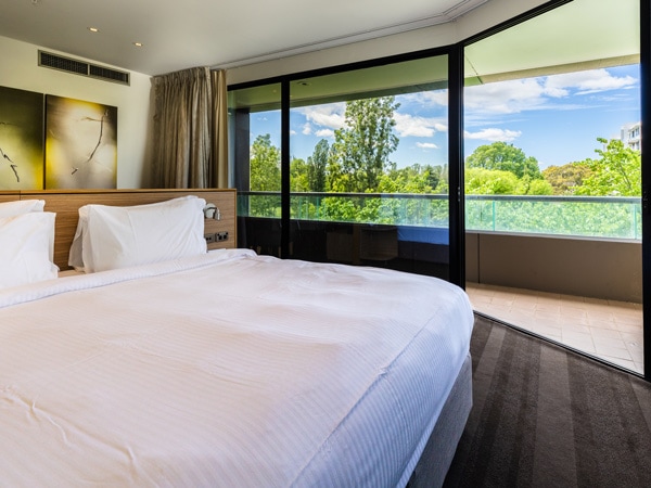 a bedroom with windows at Crowne Plaza, Canberra