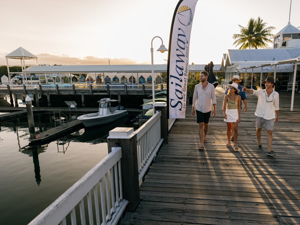 friends walking along Crystalbrook Marina Port Douglas