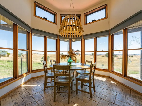 a dining space with glass walls at Luxurious Country Estate, Springrange