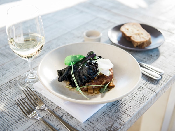 a plate of food with wine at Muse Pokolbin
