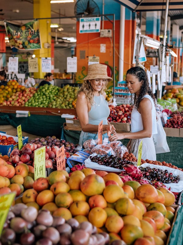 two women buying fresh fruits at a stall in Rusty's Markets