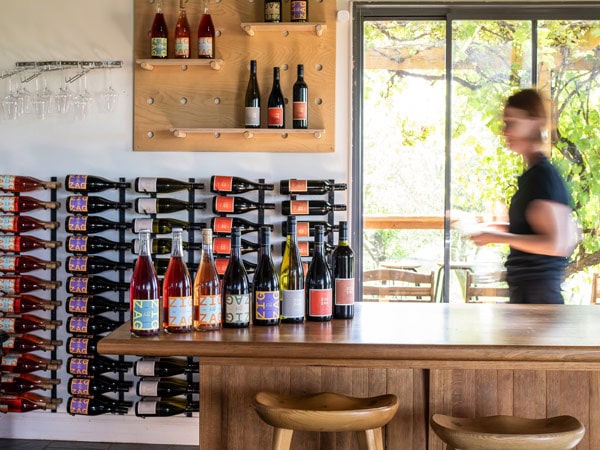 a blurry image of a woman walking inside Zig Zag Rd Wines