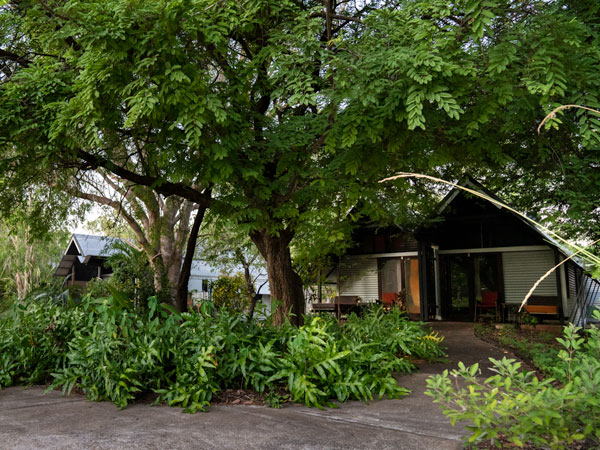 rustic cabins within lush greenery at Anbinik Kakadu Resort