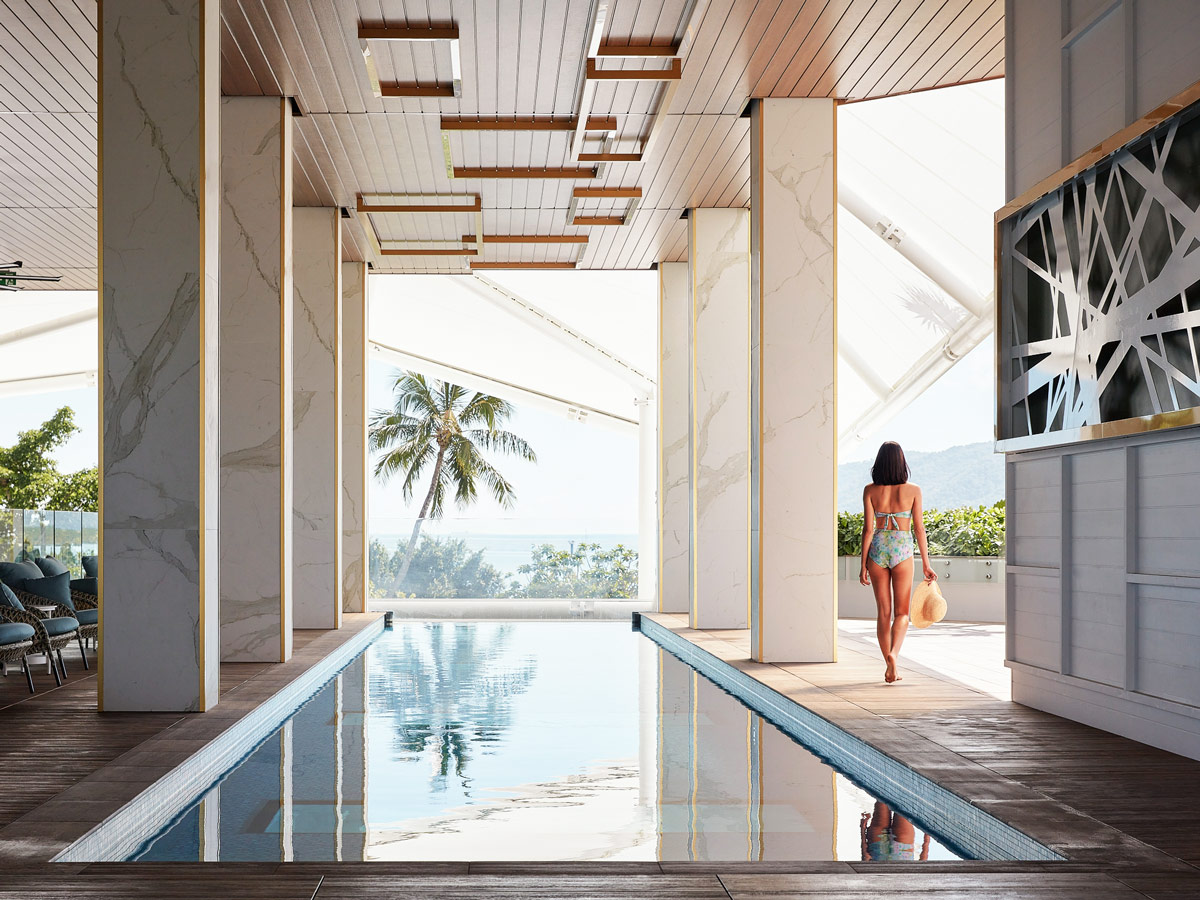 a woman walking by the pool at Crystalbrook Flynn, best accommodation in Cairns