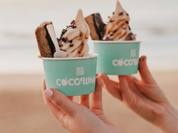 a hand holding sundae cups at Blue Door Kiosk, Newcastle