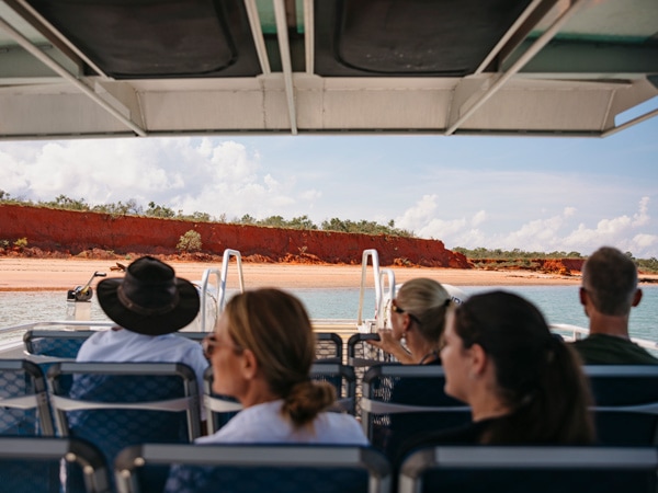 a group of tourists onboard a boat during Broome Dinosaur Adventure Tours
