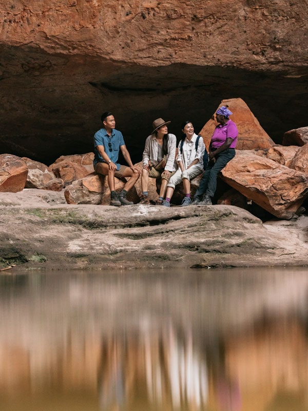 a group of tourists resting on the rocks at Cathedral Gorge, Purnululu National Park