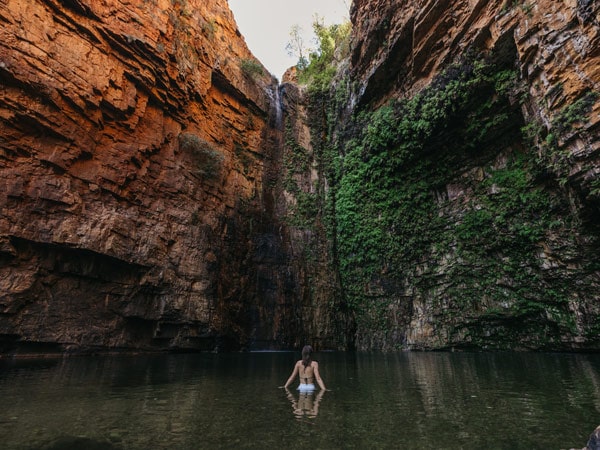 a woman dipping in the swimming hole at Emma Gorge