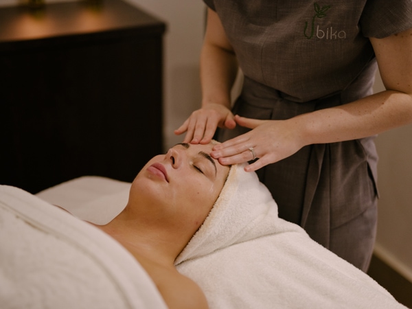 a woman getting a facial treatment at Ubika Day Spa at Rydges Resort Hunter Valley