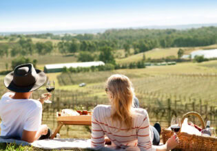 a couple enjoying a romantic date among the vines in the Hunter Valley
