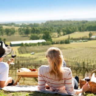 a couple enjoying a romantic date among the vines in the Hunter Valley
