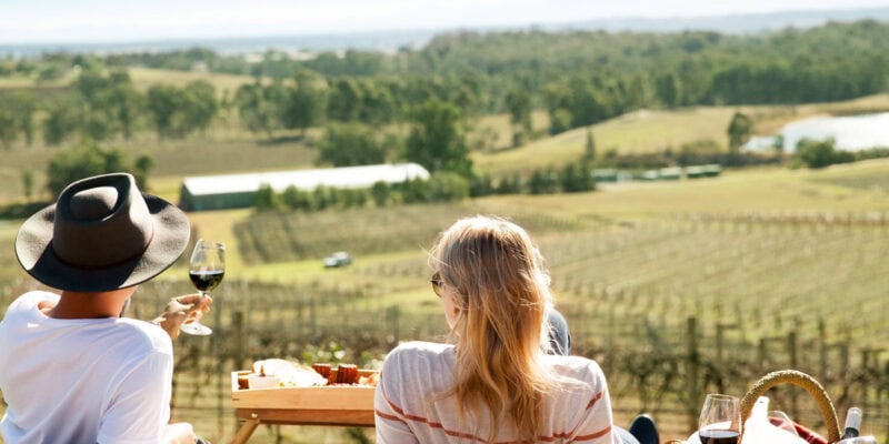 a couple enjoying a romantic date among the vines in the Hunter Valley