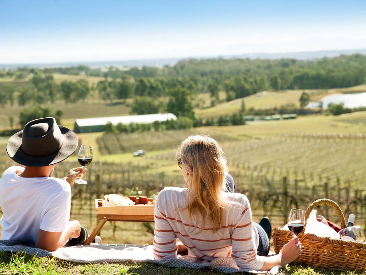 a couple enjoying a romantic date among the vines in the Hunter Valley