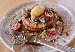 fluffy buttermilk pancakes on a plate at Goodfriends Eatery, Newcastle