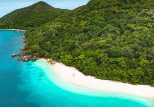an aerial view of the turquoise waters of Nudey Beach
