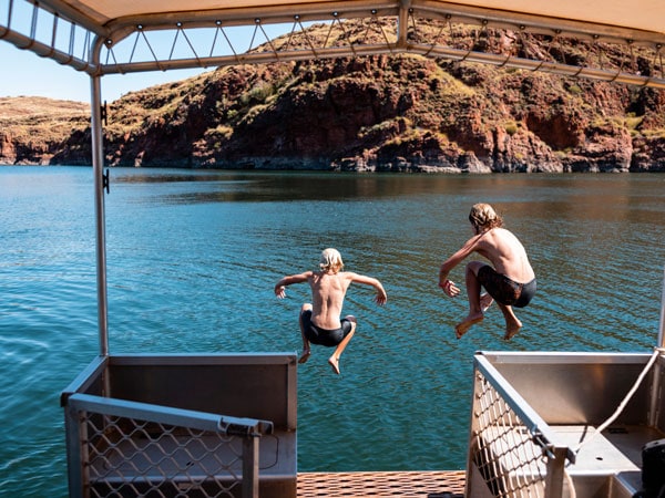 two kids jumping into the water, Lake Argyle Cruises, near Kununurra