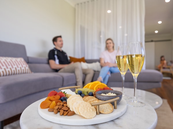 platters of cheese and fruit with two glasses of champagne at Reflections Day Spa