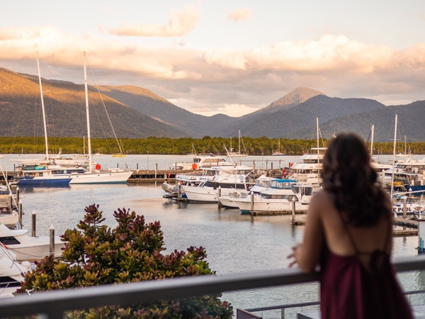 a woman standing on the balcony with Marina views at Shangri-La The Marina, Cairns