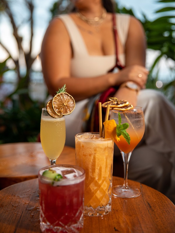 a woman enjoying cocktails at Salt House, Cairns