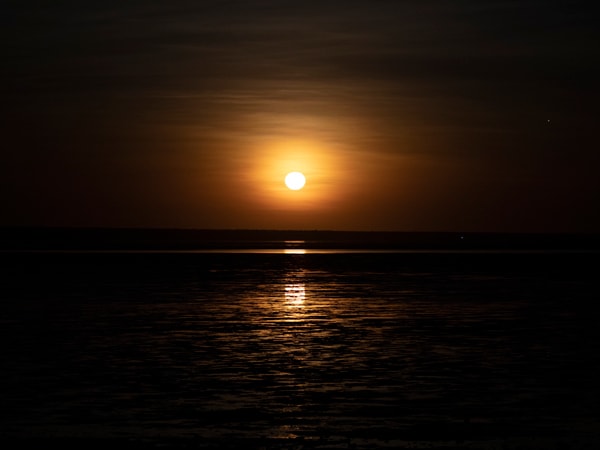 a bright full moon phenomena during the Staircase to the Moon show in The Mangrove Resort
