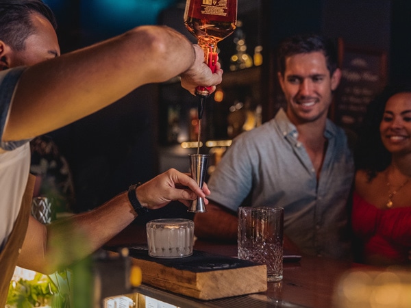 a bartender mixing drinks at Three Wolves, Cairns