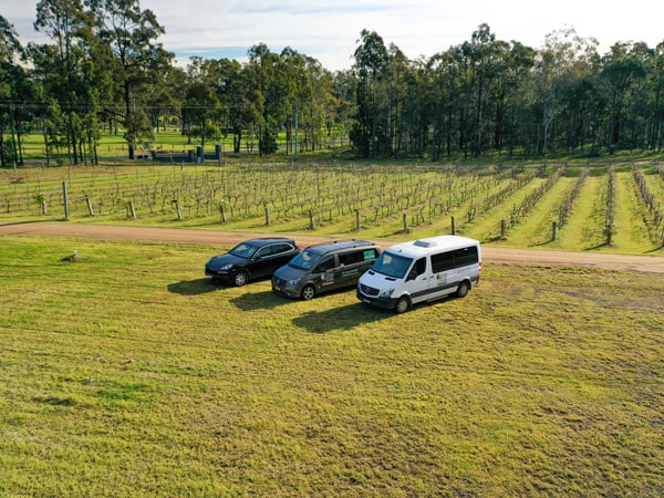 three vehicles in the middle of a vineyard at Two Fat Blokes