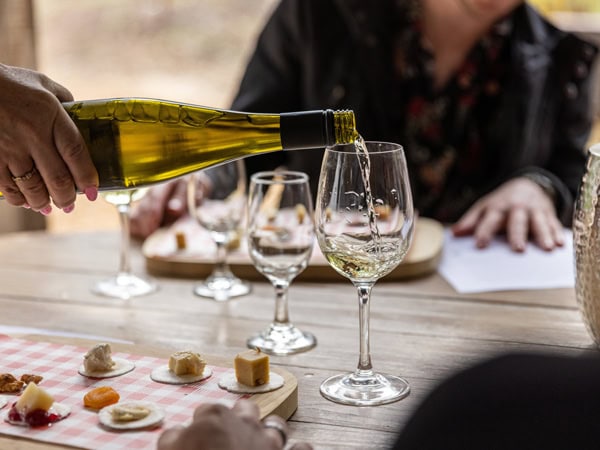 pouring wine into a glass at Two Fat Blokes, Hunter Valley