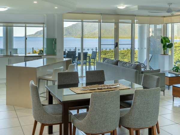 the living and dining room interior at Waters Edge Cairns Luxury Apartments