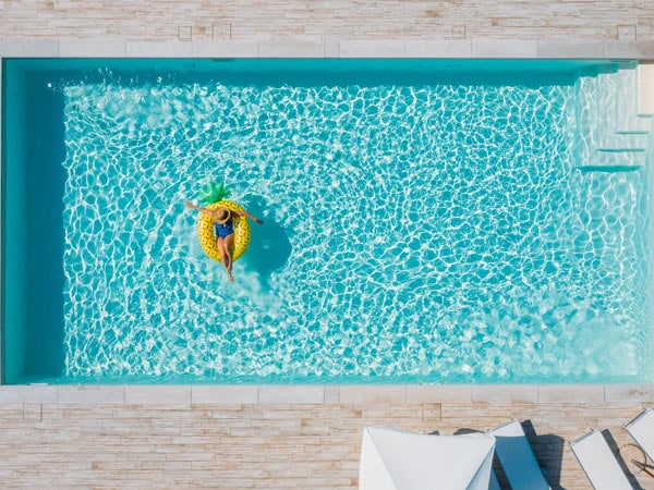 Aerial shot of woman in floaty in pool