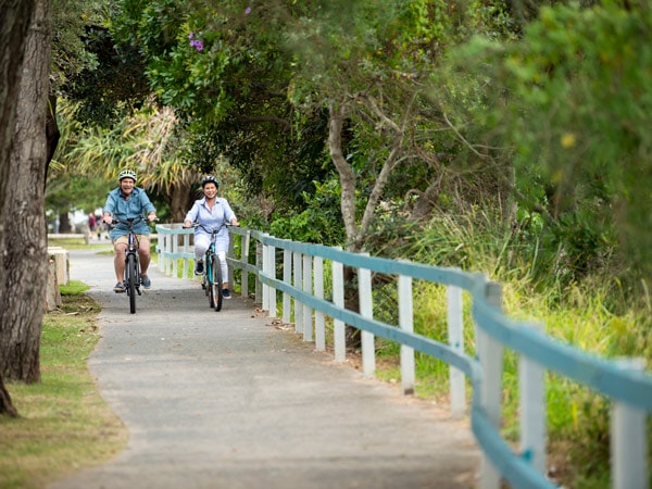 a couple enjoying a scenic bike ride in Yamba