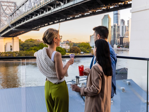 friends enjoying drinks by the Brisbane River at Fiume