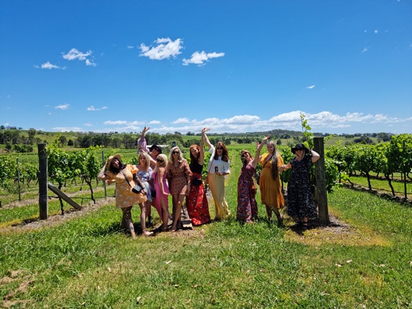 guests in a scenic vineyard at Tastes of the Hunter Wine Tours