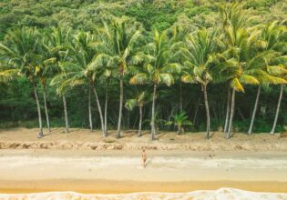 Woman coming out of the water at Ellis Beach in Cairns