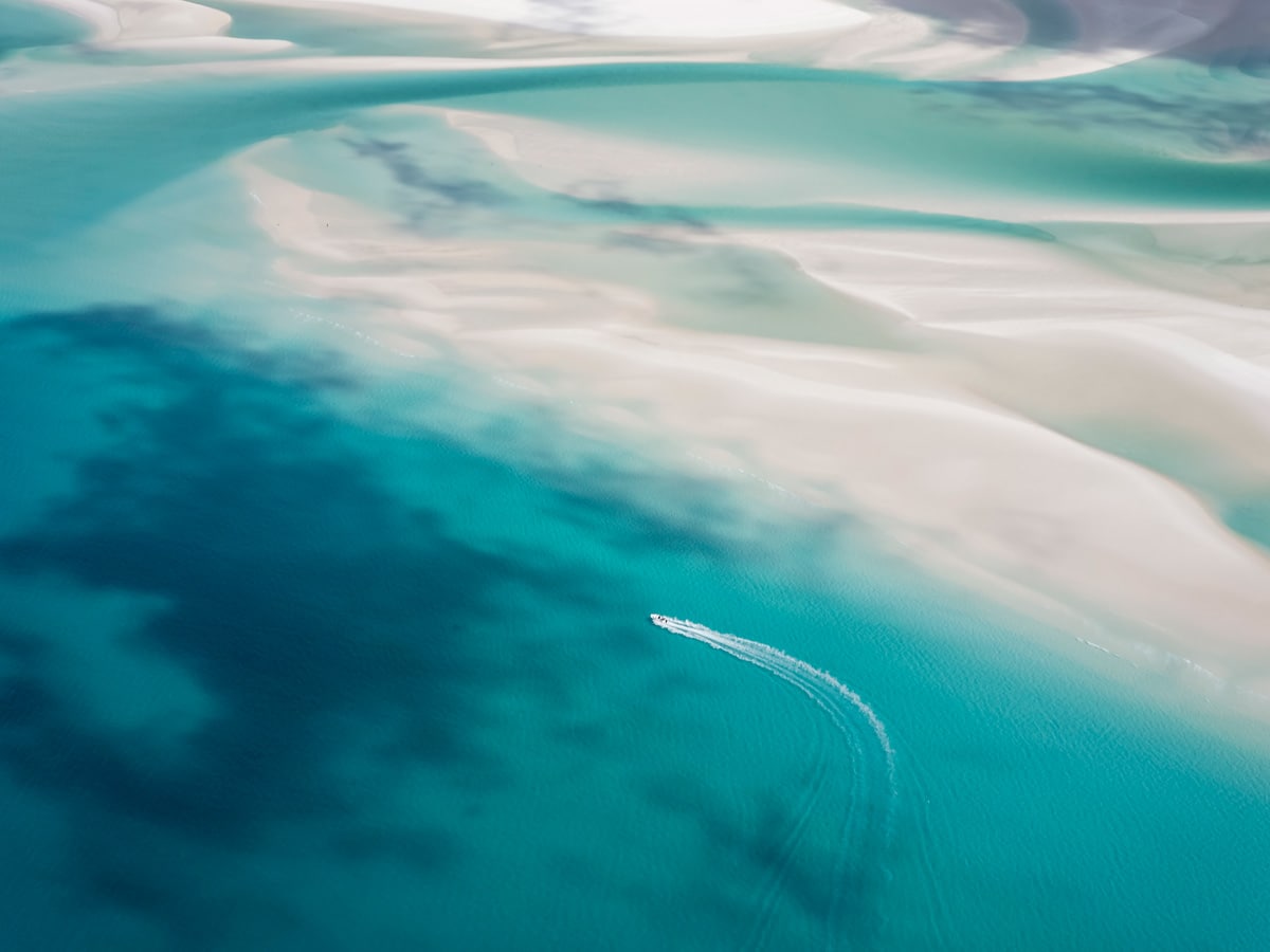 Aerial view of a boat cruising through the Whitsundays