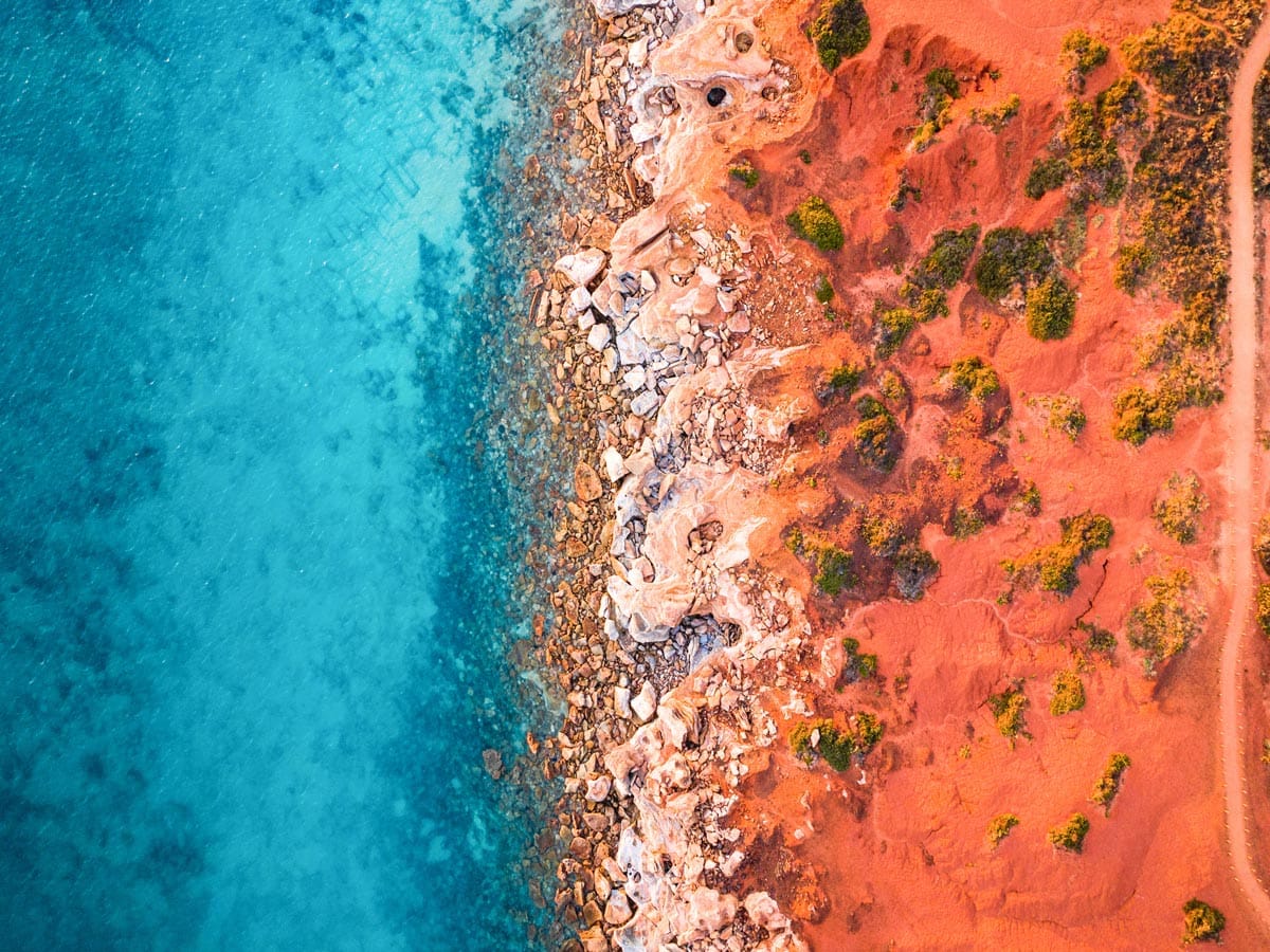 an aerial view of the sandstone cliffs of Gantheaume Point, Broome fringed by the Indian Ocean