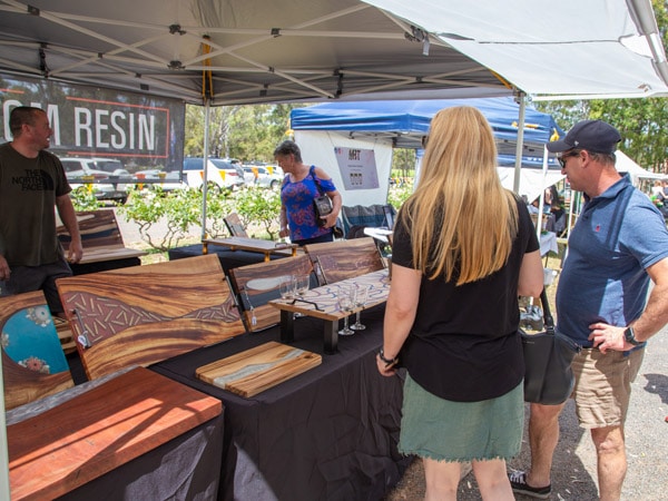 people browsing at a market stall in Handmade in the Hunter Markets